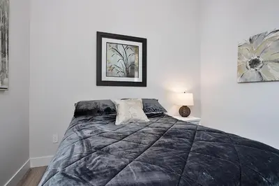 a bedroom with a bed with a black blanket at The National on Queen in Saint Marys