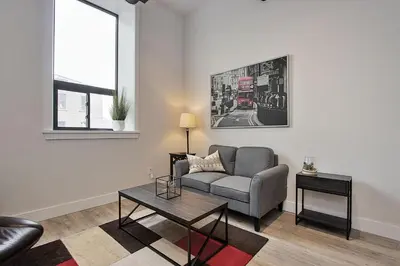 a living room with a couch and a table at The National on Queen in Saint Marys