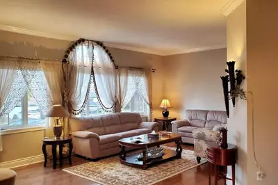 a living room with a couch and a table at Modern & Spacious 2 Bedrooms+2 Bathrooms Bungalow in Oakville in Oakville