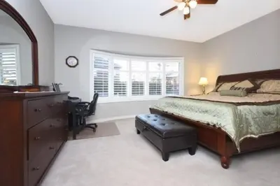 a bedroom with a bed and a dresser and a desk at Modern & Spacious 2 Bedrooms+2 Bathrooms Bungalow in Oakville in Oakville