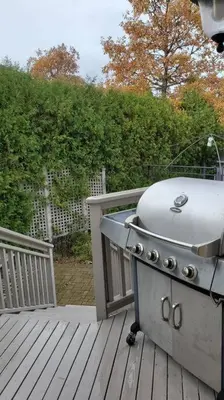a grill sitting on top of a wooden deck at Modern & Spacious 2 Bedrooms+2 Bathrooms Bungalow in Oakville in Oakville