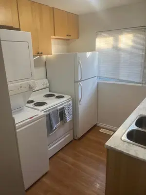 a kitchen with a stove and a refrigerator at 2plex, Choose, 1of 2 entire units apparts in Hamilton