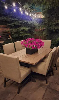 a wooden table with chairs and a pot of pink flowers at Executive House easy access to Kitchener-Waterloo, Cambridge, Toronto, walk to restaurants in Kitchener
