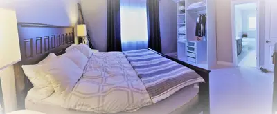 a bedroom with a large bed with white pillows at Executive House easy access to Kitchener-Waterloo, Cambridge, Toronto, walk to restaurants in Kitchener