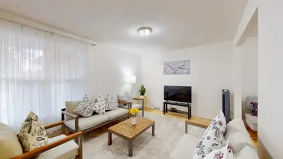 a living room with a couch and a tv at 3-Bed 3-Bath Cozy Vacation House in Ajax, Greater Toronto Area, ON, Canada in Ajax
