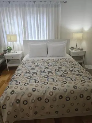 a bed in a bedroom with two tables and two lamps at 3-Bed 3-Bath Cozy Vacation House in Ajax, Greater Toronto Area, ON, Canada in Ajax