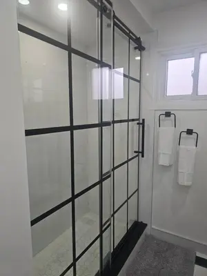 a glass shower door in a bathroom with towels at 3-Bed 3-Bath Cozy Vacation House in Ajax, Greater Toronto Area, ON, Canada in Ajax