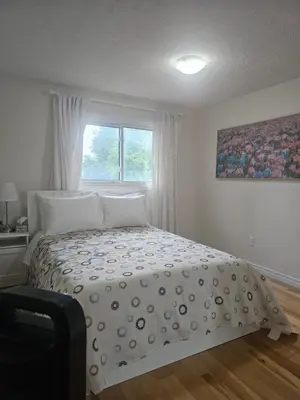 a bedroom with a bed and a window at 3-Bed 3-Bath Cozy Vacation House in Ajax, Greater Toronto Area, ON, Canada in Ajax