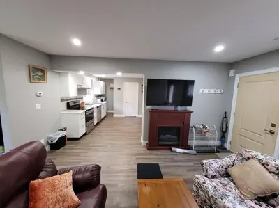 a living room with a couch and a tv at Cozy 3-bedroom farmhouse in wine-country in Niagara on the Lake