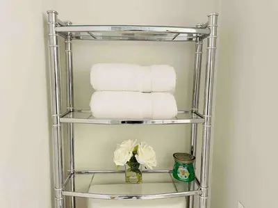 a towel rack with towels and a vase of flowers at Comfortable Apartment in Richmond Hill in Richmond Hill