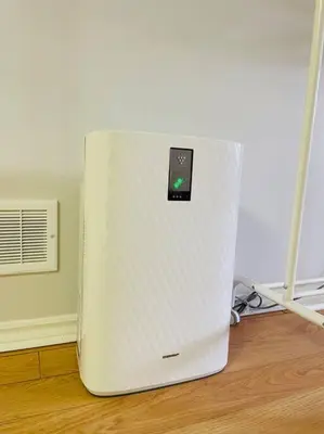 a white refrigerator sitting on top of a wooden floor at Comfortable Apartment in Richmond Hill in Richmond Hill