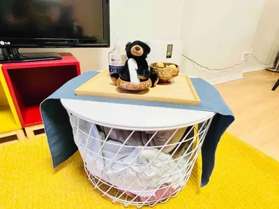 a table with a shelf with a stuffed penguin on it at Comfortable Apartment in Richmond Hill in Richmond Hill