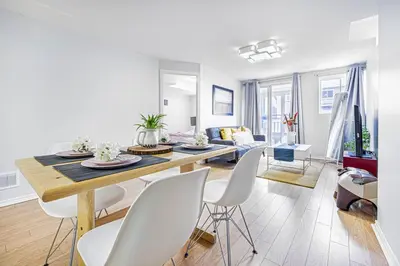 a dining room and living room with a table and chairs at Comfortable Apartment in Richmond Hill in Richmond Hill