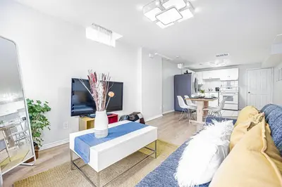 a living room with a couch and a table at Comfortable Apartment in Richmond Hill in Richmond Hill