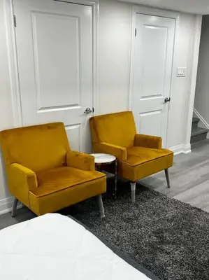 two yellow chairs and a table in a room at New Luxurious Studio Apartment in Brampton