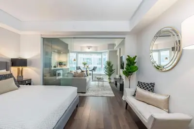 a bedroom with a bed and a living room at Yorkville Living 1 BR-1BA with Gym in Upscale Area in Toronto