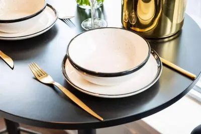 a black table with two plates and a fork at Yorkville Living 1 BR-1BA with Gym in Upscale Area in Toronto