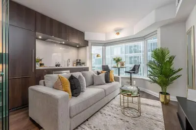 a living room with a couch and a table at Yorkville Living 1 BR-1BA with Gym in Upscale Area in Toronto