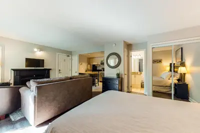 a bedroom with a bed and a mirror at Condo 208 At North Creek Resort in Blue Mountains