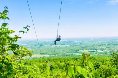 a man on a zip line in the jungle at Condo 208 At North Creek Resort in Blue Mountains