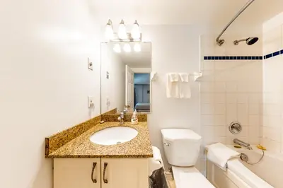 a bathroom with a sink and a toilet and a mirror at Condo 208 At North Creek Resort in Blue Mountains