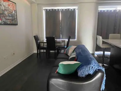 a living room with a couch and a table at Poise Homes Guest Home Cambridge in Cambridge
