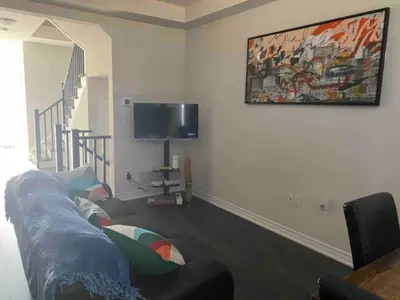 a living room with a couch and a flat screen tv at Poise Homes Guest Home Cambridge in Cambridge