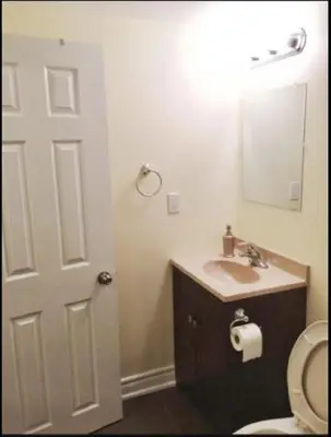 a bathroom with a toilet and a sink and a mirror at Cozy & Spacious Suite with Private Bathroom near Toronto Airport ! in Mississauga