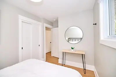 a bedroom with a bed and a mirror on the wall at The Newark House in Niagara on the Lake