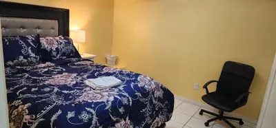 a bedroom with a bed and a chair at Cozy private room in Brampton