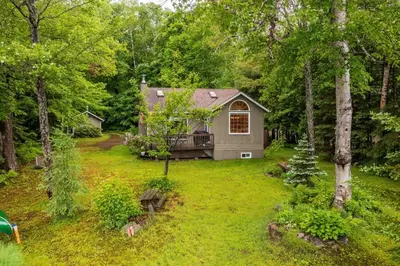 a small house in the middle of a yard at Bear Essentials Hideaway in Huntsville