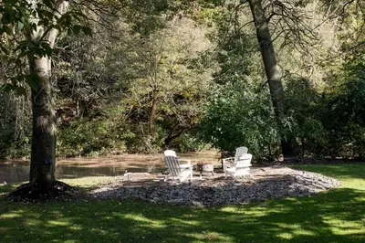 a group of chairs sitting on a circle in the grass at Disconnect From Reality/ River House/Hot Tub/Pet Friendly in Port Burwell