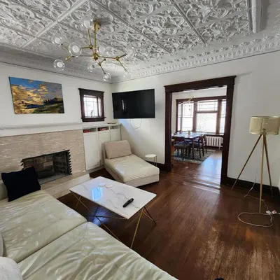 a living room with a couch and a fireplace at The Pandora Century Home in Kitchener
