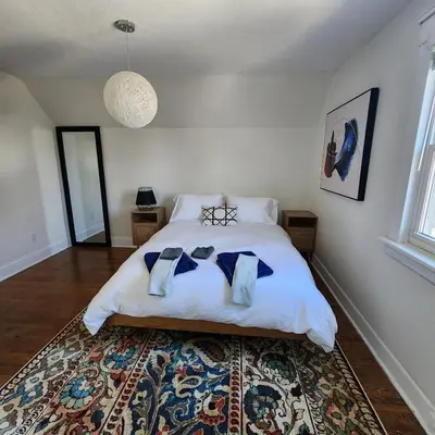 a bedroom with a bed with two pillows on it at The Pandora Century Home in Kitchener