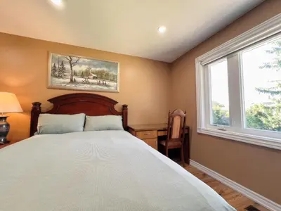 a bedroom with a bed and a window at Spacious Rooms with Bath Near Wonderland & Vaughan Mills Mall in Vaughan