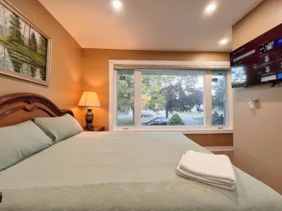 a bedroom with a large bed and a window at Spacious Rooms with Bath Near Wonderland & Vaughan Mills Mall in Vaughan