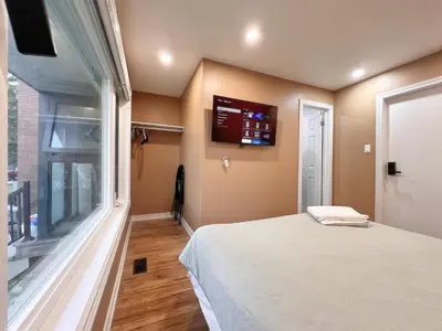 a bedroom with a bed and a large window at Spacious Rooms with Bath Near Wonderland & Vaughan Mills Mall in Vaughan