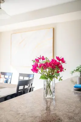 a vase filled with pink flowers sitting on a table at GlobalStay 3 Bedroom Townhouse Near Niagara Falls Brock University in Thorold