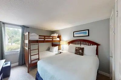 a bedroom with two bunk beds and a window at Wintergreen 125 in Blue Mountains
