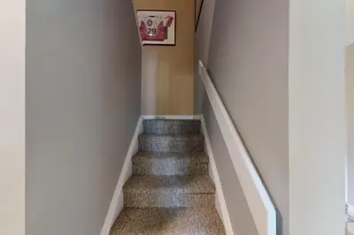 a staircase in a home with gray carpet at Wintergreen 125 in Blue Mountains