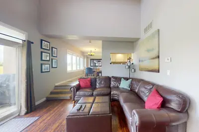 a living room with a brown leather couch at Wintergreen 125 in Blue Mountains