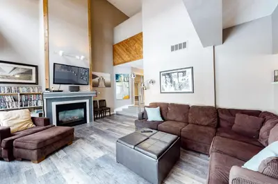 a living room with a couch and a fireplace at Wintergreen 116 in Blue Mountains