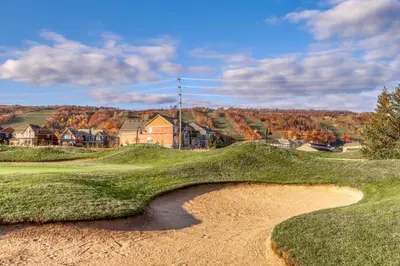 a bunker on a golf course with a hill in the background at Wintergreen 116 in Blue Mountains