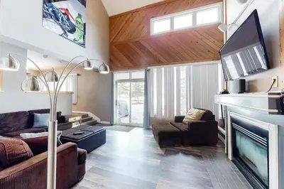 a living room with a couch and a fireplace at Wintergreen 116 in Blue Mountains