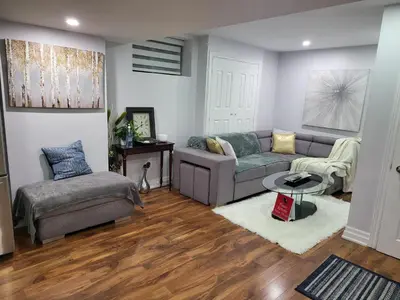 a living room with a couch and a chair at Luxurious Apt 2BRs-1BA Spacious Modern, with free parking in Brampton