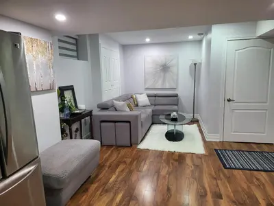 a living room with a couch and a table at Luxurious 1BR-1BA Apartment Bright Spacious with free parking-gc-1 in Brampton