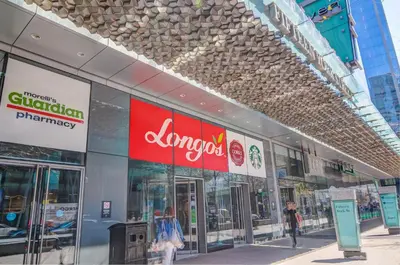 an amazon store in a city with people walking outside at Stunning 2 BD in heart of Toronto with Parking in Toronto