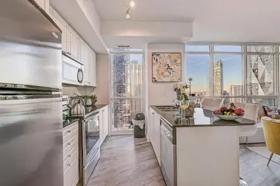 a kitchen with a view of a city at Stunning 2 BD in heart of Toronto with Parking in Toronto