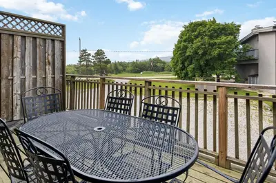 a table and chairs on a balcony with a fence at Semi Detached Mountain View Chalet in Blue Mountains