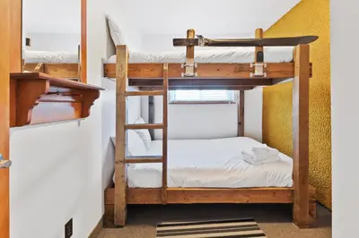 a bunk bed room with two bunk beds and a ladder at Semi Detached Mountain View Chalet in Blue Mountains